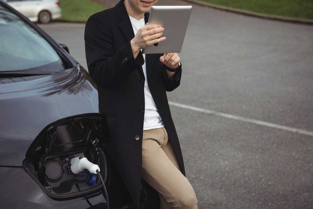 Clients reviewing electric fleet budget options on an iPad